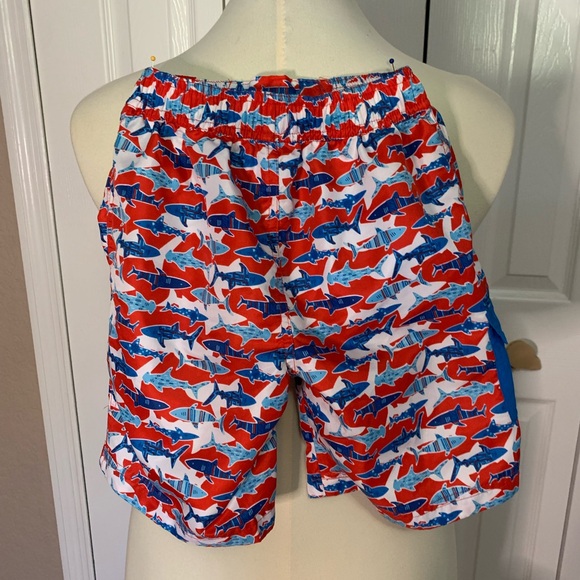 Shark print red and blue UV Skins boys swim trunks. - Picture 2 of 4